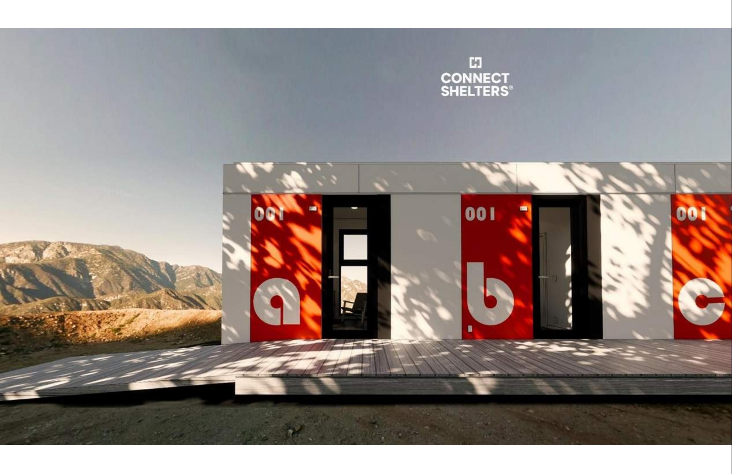 A row of Connect Shelter 3 units with iconic red doors in a mountain setting.
